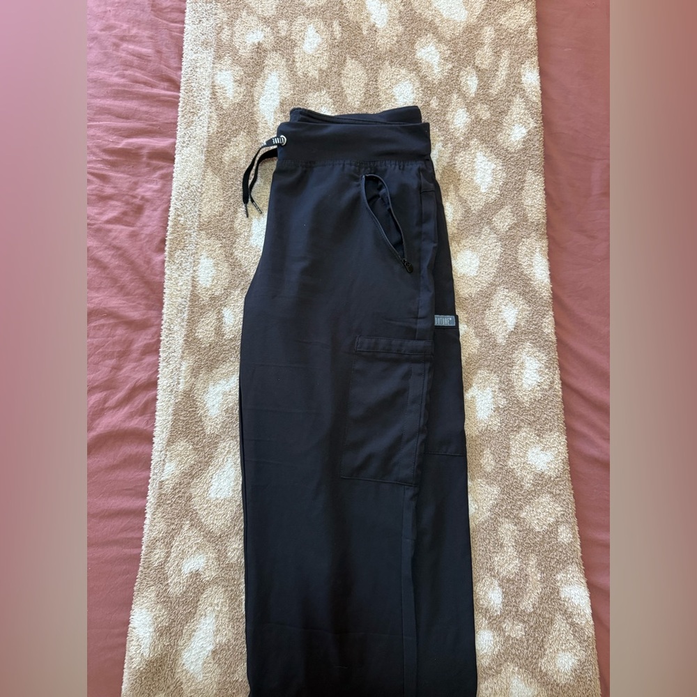 Medium sized black med couture wide leg scrub pants.